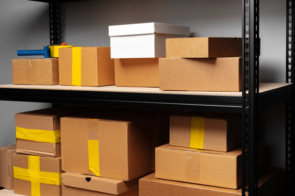 Sealed cartons of finished apparel stacked in a warehouse and ready for international shipment.